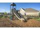 Community playground featuring modern play structures, a picnic table, and a well-maintained safety surface at 817 James J Freeland Memorial Dr, Hillsborough, NC 27278