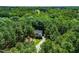 Aerial view showcases a home surrounded by lush trees in a neighborhood setting at 83 Calabria Ct, Clayton, NC 27527