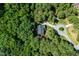 An aerial view of a home nestled in a lush, green forest setting at 83 Calabria Ct, Clayton, NC 27527