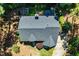 Aerial view of home with gray roof, set on landscaped lot with mature trees at 83 Calabria Ct, Clayton, NC 27527