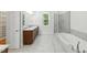 Bathroom featuring dual vanities, granite countertops, separate tub and shower at 83 Calabria Ct, Clayton, NC 27527