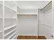 Walk-in closet featuring custom built-in shelving and hardwood floors at 83 Calabria Ct, Clayton, NC 27527