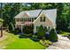 Gorgeous aerial view of a brick home with lush landscaping and a well-manicured lawn at 83 Calabria Ct, Clayton, NC 27527