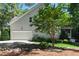 Exterior view of a house showing the garage, side yard, landscaping, and generator at 83 Calabria Ct, Clayton, NC 27527