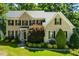 Attractive brick home with a covered entrance, mature trees and lush lawn at 83 Calabria Ct, Clayton, NC 27527