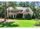 Charming two-story brick home with lush front lawn and mature trees, offering classic curb appeal at 83 Calabria Ct, Clayton, NC 27527