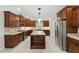 Gourmet kitchen with cherry wood cabinets, stainless steel appliances, granite countertops and an oversized kitchen island at 83 Calabria Ct, Clayton, NC 27527