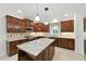 Gourmet kitchen with cherry wood cabinets, stainless steel appliances, granite countertops and an oversized kitchen island at 83 Calabria Ct, Clayton, NC 27527