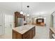 Spacious gourmet kitchen featuring granite countertops, stainless steel appliances, a kitchen island, and tile flooring at 83 Calabria Ct, Clayton, NC 27527