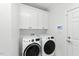 Laundry room with white cabinets, washer, and dryer at 83 Calabria Ct, Clayton, NC 27527