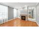 Living room featuring hardwood floors, a brick fireplace and built-in shelving at 83 Calabria Ct, Clayton, NC 27527
