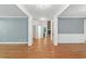An open-concept room with hardwood floors, white trim, and a view of a fireplace at 83 Calabria Ct, Clayton, NC 27527