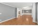 Living room features wood floors, gray walls, white trim, and an open entrance to the dining room at 83 Calabria Ct, Clayton, NC 27527
