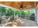 Relaxing screened porch featuring wood flooring, a ceiling fan, and serene views of the surrounding natural landscape at 83 Calabria Ct, Clayton, NC 27527