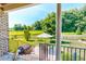 Outdoor patio with a grill, an umbrella-covered table, and a serene view of the backyard at 90 S Old Lantern Rd, Timberlake, NC 27583