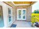 Covered back porch featuring brick accents, access doors, and views of the back yard at 90 S Old Lantern Rd, Timberlake, NC 27583