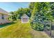 Exterior view of a backyard shed or garage with a well-maintained lawn and fencing at 90 S Old Lantern Rd, Timberlake, NC 27583