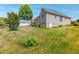Large backyard showing brick home, grass and trees at 90 S Old Lantern Rd, Timberlake, NC 27583