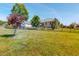 Expansive backyard with lush green grass, trees and a black metal fence at 90 S Old Lantern Rd, Timberlake, NC 27583