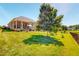 Spacious backyard with a lush green lawn and covered patio, great for outdoor activities at 90 S Old Lantern Rd, Timberlake, NC 27583