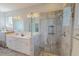 Bright bathroom featuring double vanity, glass enclosed shower, grab bars and tile flooring at 90 S Old Lantern Rd, Timberlake, NC 27583