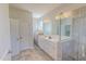 Bright bathroom featuring double vanity, glass enclosed shower, and tile flooring at 90 S Old Lantern Rd, Timberlake, NC 27583