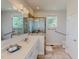 Bright bathroom featuring double vanity, glass enclosed shower, grab bars and tile flooring at 90 S Old Lantern Rd, Timberlake, NC 27583