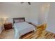 Bedroom with wood flooring, a ceiling fan, and a bedside table at 90 S Old Lantern Rd, Timberlake, NC 27583