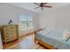Bright bedroom with wooden floors, a ceiling fan, and a large window at 90 S Old Lantern Rd, Timberlake, NC 27583