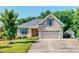 Beautiful home with manicured lawn, brick exterior, mature trees, and attached two car garage at 90 S Old Lantern Rd, Timberlake, NC 27583