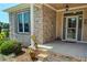 Charming front porch with brick accents, covered entrance, and garden views at 90 S Old Lantern Rd, Timberlake, NC 27583