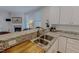 Modern kitchen featuring granite counters, stainless steel sink, and pass-through to living area at 90 S Old Lantern Rd, Timberlake, NC 27583