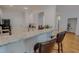 Bright kitchen with granite countertops, stainless steel appliances, and breakfast bar with seating at 90 S Old Lantern Rd, Timberlake, NC 27583