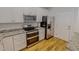 Modern kitchen features stainless steel appliances, granite counters, and white cabinets at 90 S Old Lantern Rd, Timberlake, NC 27583