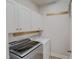 Functional laundry room with overhead cabinets and modern washer and dryer at 90 S Old Lantern Rd, Timberlake, NC 27583