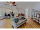 Open-concept living room with hardwood floors, comfortable seating, and seamless flow to the kitchen and dining areas at 90 S Old Lantern Rd, Timberlake, NC 27583
