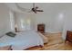 Bright main bedroom with hardwood floors, ceiling fan, and access to the outdoors at 90 S Old Lantern Rd, Timberlake, NC 27583