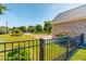 Landscaped yard with a black metal fence and a view of the neighborhood at 90 S Old Lantern Rd, Timberlake, NC 27583