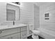 Nicely updated bathroom with shiplap walls, black floors and marble tiled shower at 904 Lanier Farm Rd, Sanford, NC 27330