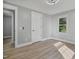 Bedroom with new floors, gray paint, new closet and a window at 904 Lanier Farm Rd, Sanford, NC 27330