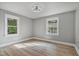 Bedroom with new floors, gray paint and two large windows at 904 Lanier Farm Rd, Sanford, NC 27330