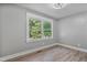 A well-lit bedroom with a large window and modern vinyl floors offers a clean and inviting space at 904 Lanier Farm Rd, Sanford, NC 27330