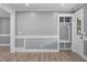 Well-lit entryway featuring a storage bench with hooks, modern floors, and fresh gray paint at 904 Lanier Farm Rd, Sanford, NC 27330