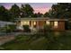 Charming brick home featuring a covered front porch with a white railing and well-maintained landscaping at 904 Lanier Farm Rd, Sanford, NC 27330