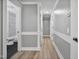 Hallway with doors leading to rooms and a bathroom with black floor and tile shower at 904 Lanier Farm Rd, Sanford, NC 27330