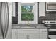 Kitchen with white cabinets, stainless appliances, granite countertops, tile backsplash and a window at 904 Lanier Farm Rd, Sanford, NC 27330