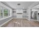 Open-concept living room with modern flooring, light gray walls, and ample natural light at 904 Lanier Farm Rd, Sanford, NC 27330