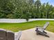 A backyard featuring a privacy fence, grass, and patio with chairs to create a relaxing atmosphere at 100 Haddonfield Ct, Franklinton, NC 27525