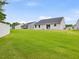 Lush backyard with manicured lawn, providing an inviting outdoor space and beautiful view of neighboring properties at 100 Haddonfield Ct, Franklinton, NC 27525