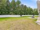 Expansive backyard featuring a well-maintained lawn, privacy fence, and patio with Adirondack chairs at 100 Haddonfield Ct, Franklinton, NC 27525